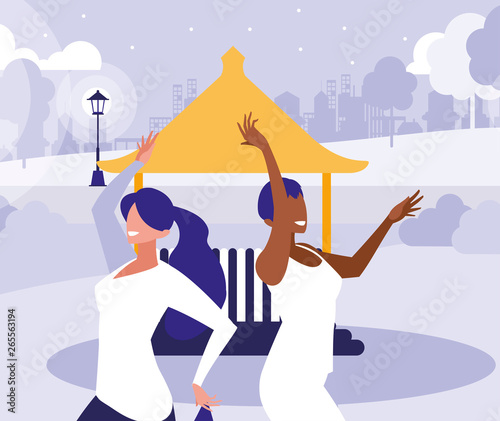 young interracial girls dancing in the park