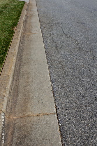 Residential street with formed curb and nicely edged grass, vertical aspect