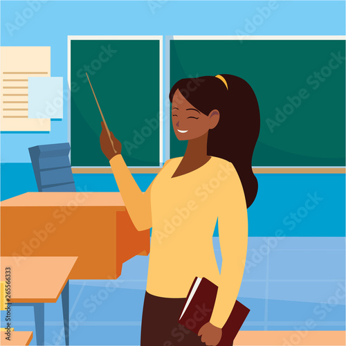 black female teacher with textbook in classroom