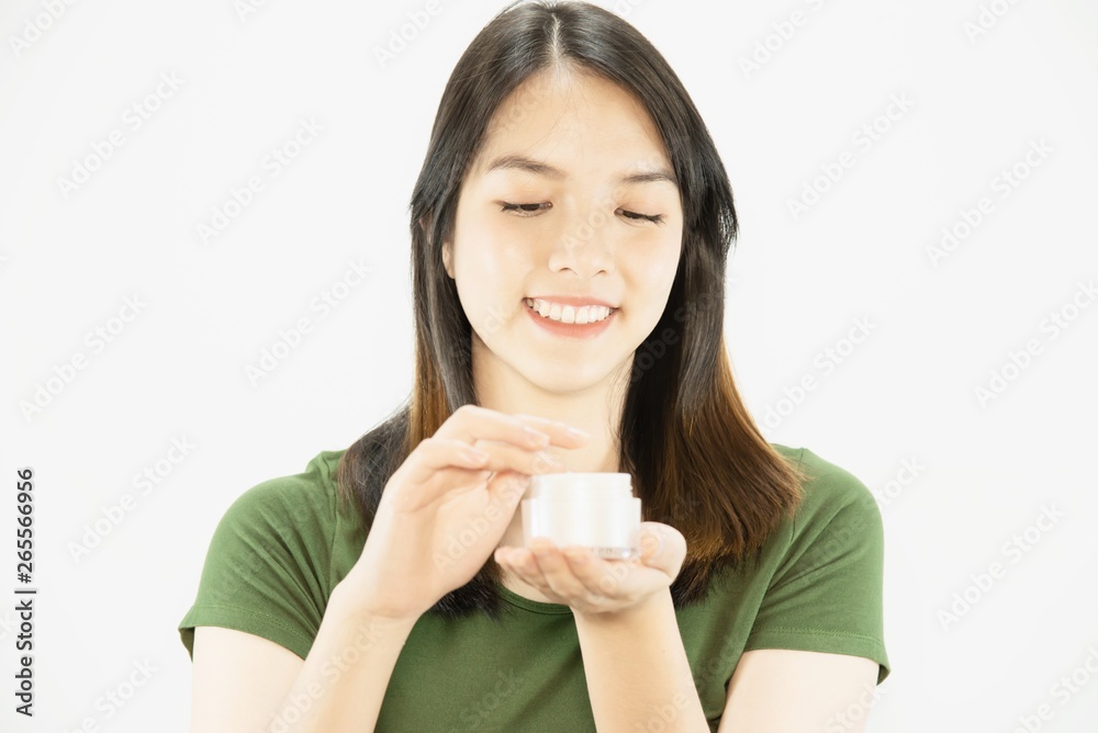 Young beautiful lady using moisturizer cream for face skin care - woman and cosmetic makeup face beauty skin care concept Young beautiful lady using moisturizer cream for face skin care - woman and cosmetic makeup face beauty skin care concept