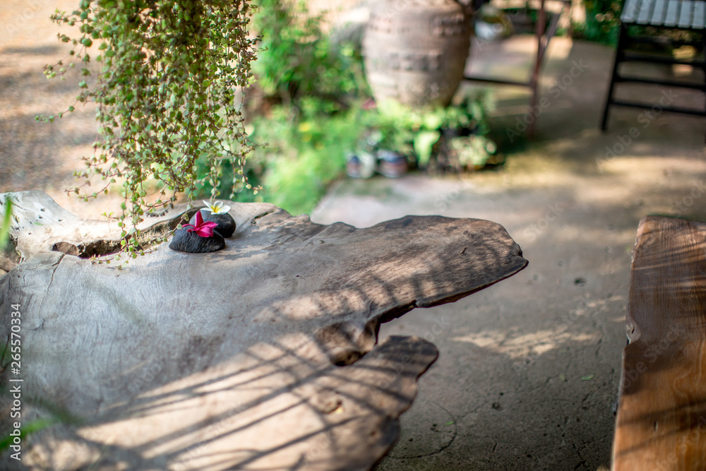 Blurred background of decorative items on wooden tables (flower vases, stones, newspapers, glassware) that are beautifully decorated to satisfy the customers who come to use in the shop. Blurred background of decorative items on wooden tables (flower vases, stones, newspapers, glassware) that are beautifully decorated to satisfy the customers who come to use in the shop.