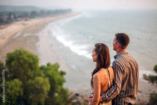 Couple on the hill looks out to sea