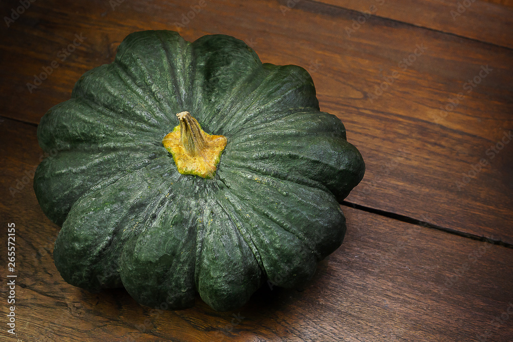 green pumpkin on wood table image close up. green pumpkin on wood table image close up.