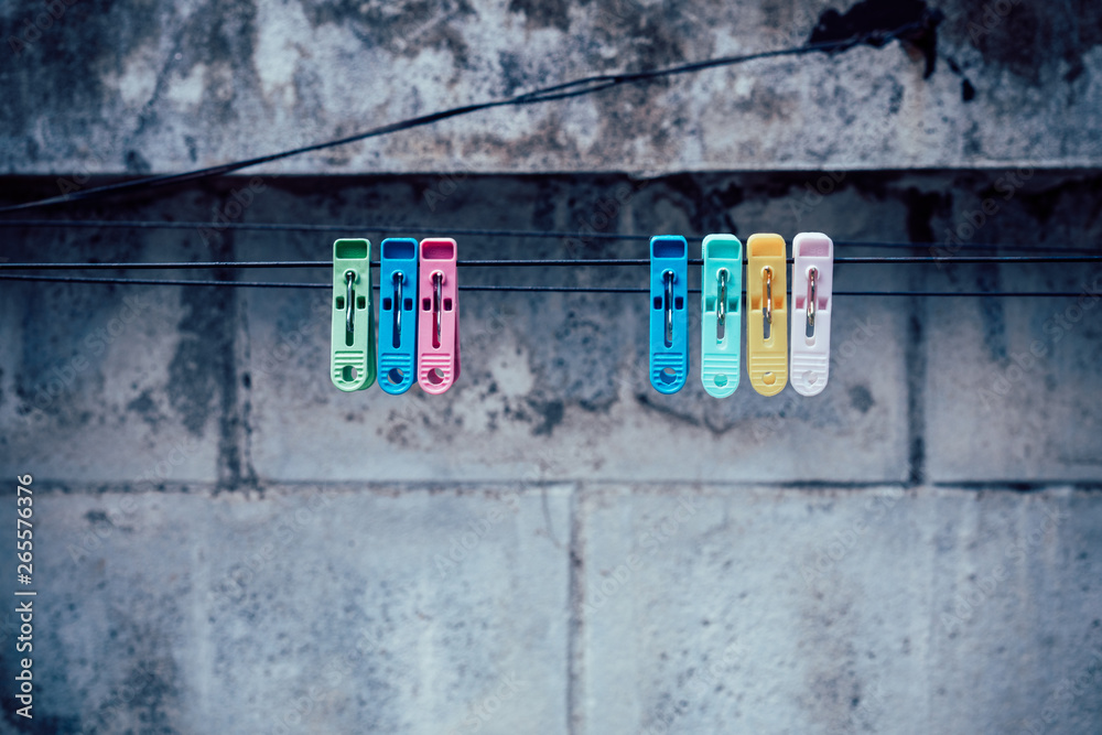 Colorful clothespin clothespins on the hangers with old wall Colorful clothespin clothespins on the hangers with old wall