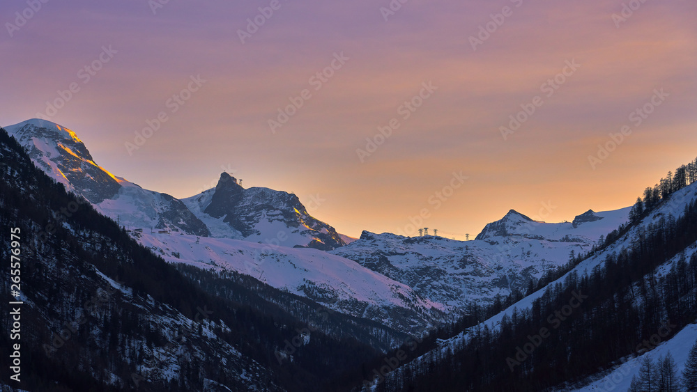 Winter Alps mountain range view at twilight time.