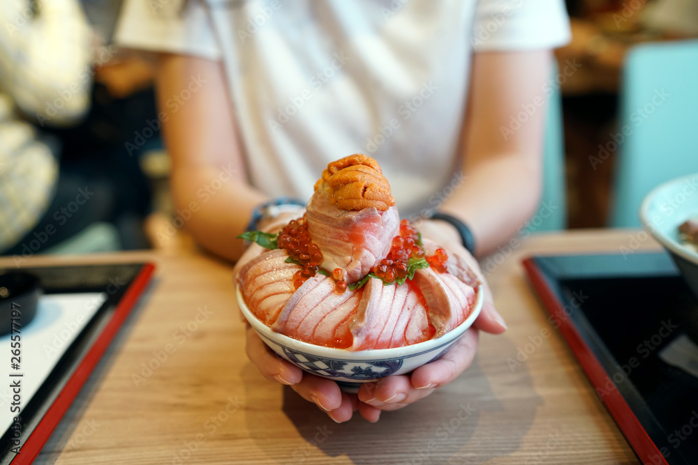 Aburi salmon, ikura and uni donburi Japanese rice bowl topped with