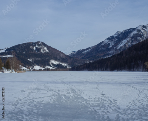 Frozen lake with mountains in the background