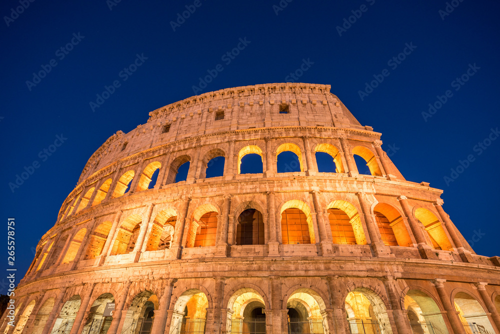 Fototapeta premium Night view of Colosseum in Rome, Italy. Rome architecture and landmark. Rome Colosseum is one of the main attractions of Rome and Italy