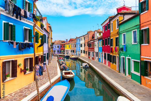Colourfully painted house facade on Burano island, province of Venice, Italy © martinhosmat083