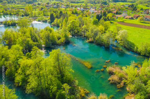 Croatia, green countryside, Mreznica river from air, panoramic view of Belavici village, waterfalls in spring, popular tourist destination