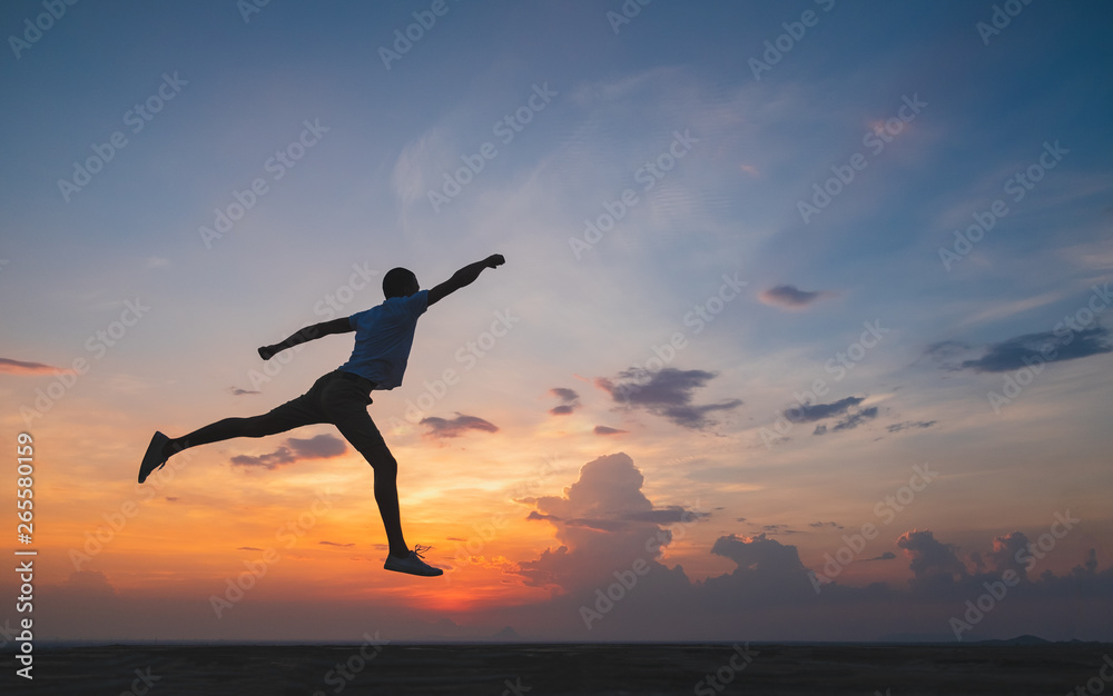 Happy man jumping for joy on the peak of the mountain, cliff at sunset. Success, winner, happiness Happy man jumping for joy on the peak of the mountain, cliff at sunset. Success, winner, happiness
