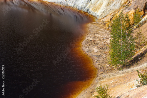 Black artificial lake and hills - mining and production of copper in Bor, Serbia photo