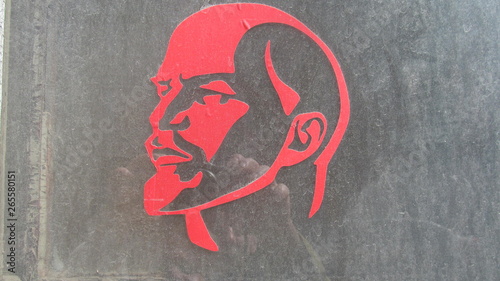 red silhouette of Lenin on the old glass  