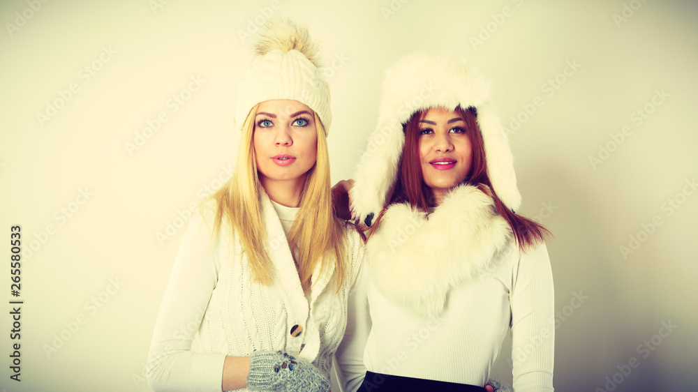 Two women with winter clothes.