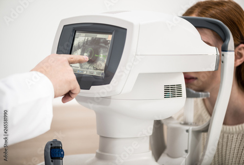 young girl patient on reception at doctor ophthalmologist. diagnostic ophthalmologic equipment. medicine concept