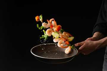 Seafood, Professional cook prepares shrimps with sprigg beans. Frost in the air, Cooking seafood, healthy vegetarian food