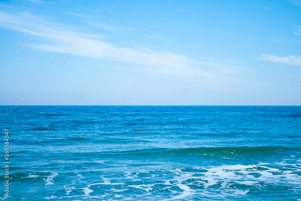 Horizon between blue sea and blue sky
