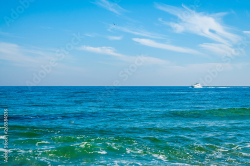 The movement of the yacht on the horizon between the sea and the sky