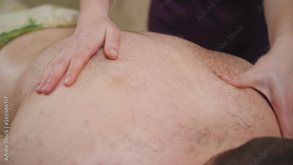 Female masseur doing massage man in the Spa salon. Female masseur doing massage man in the Spa salon.