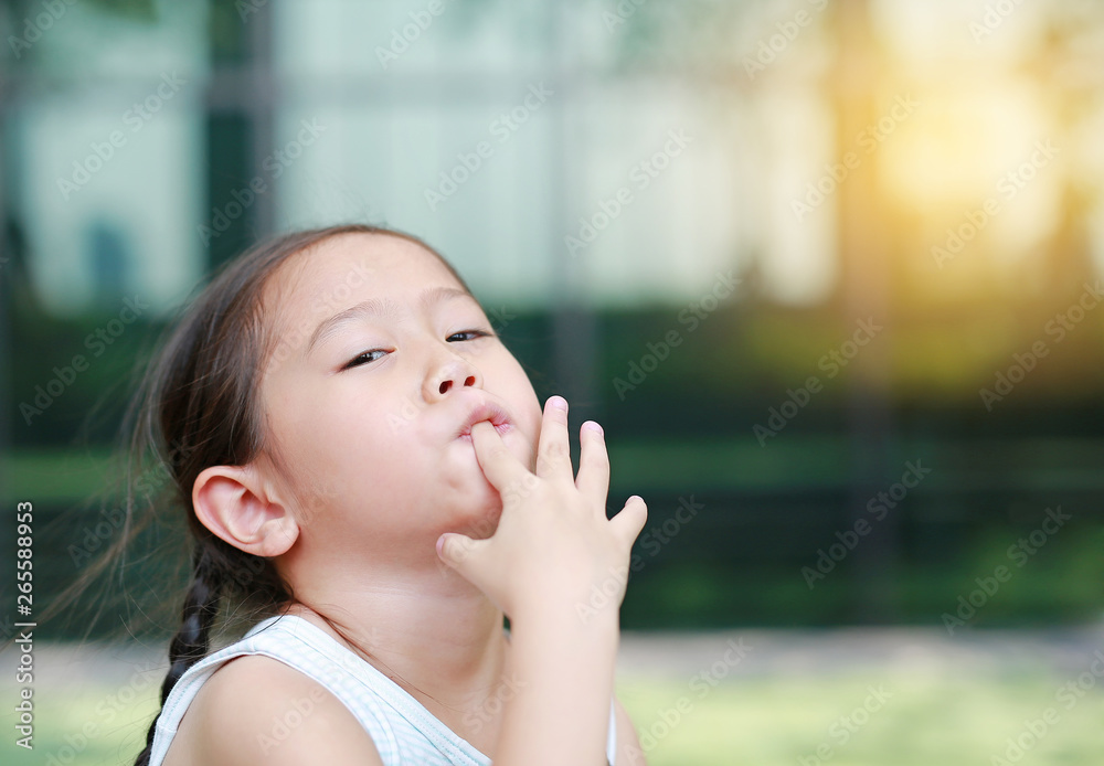 Child girl intend sucking her fingers. Child girl intend sucking her fingers.