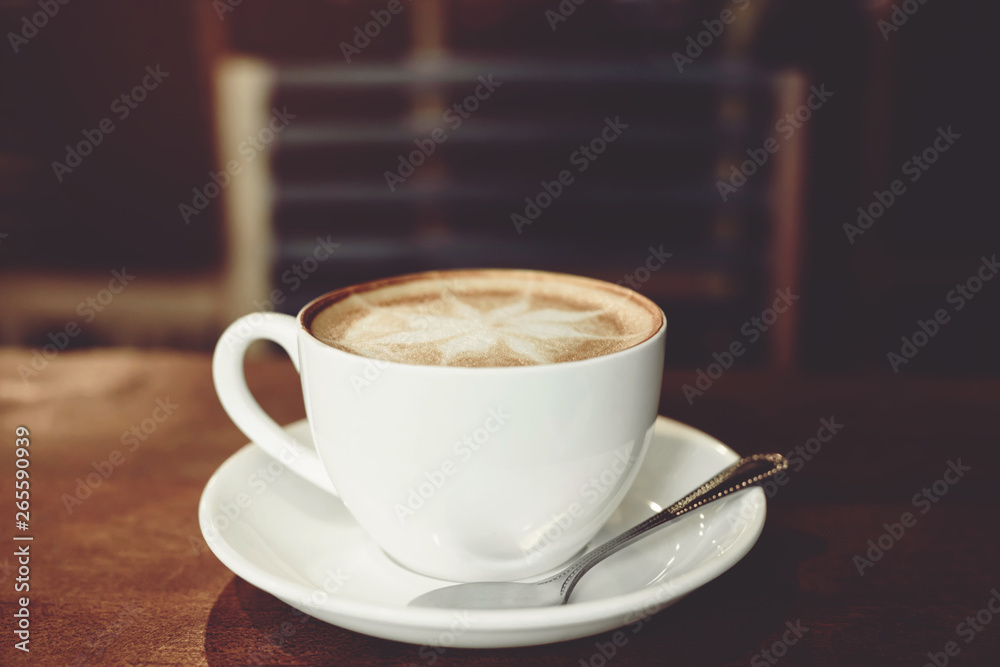 hot coffee cup latte art with spoon Serve ready to drink in cafe on wooden table coffee shop. Leave copy space empty to write the side text. soft focus. hot coffee cup latte art with spoon Serve ready to drink in cafe on wooden table coffee shop. Leave copy space empty to write the side text. soft focus.