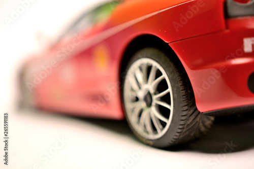Red sports car model rear view on white background