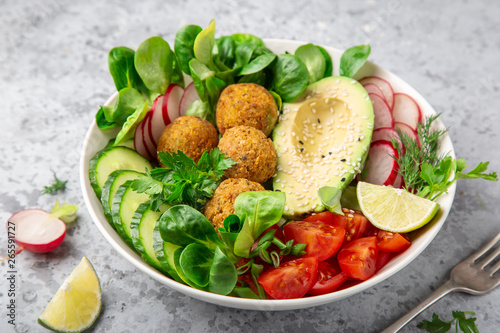 salad with avocado, falafel,cucumber, tomato and redish, healthy vegan lunch bowl