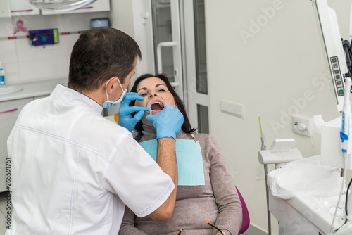 Dentist working with patient in dentist office