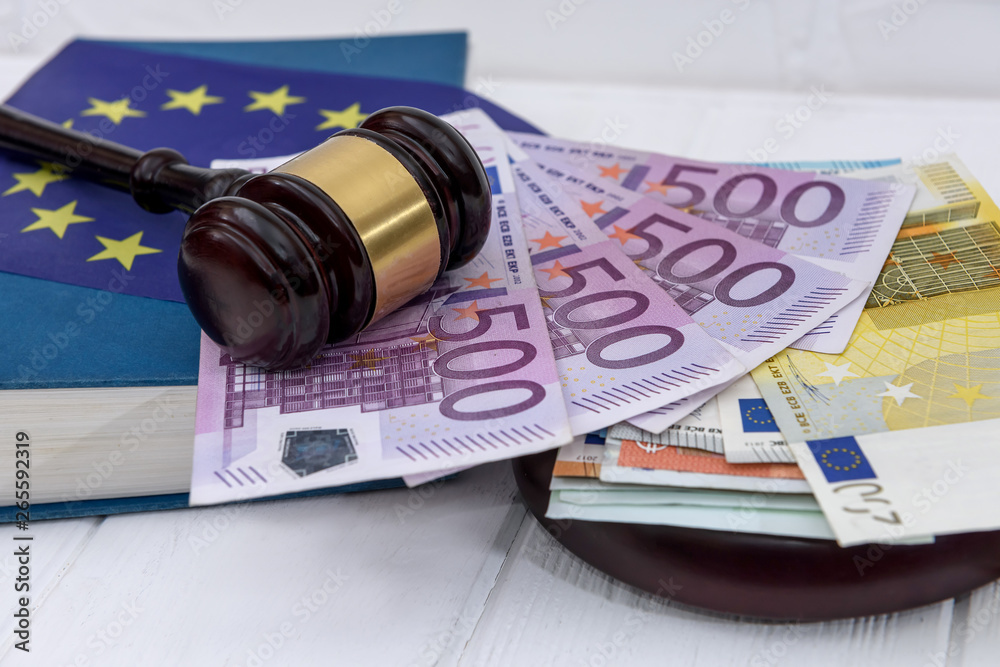 Handcuffs with euro banknotes and judge's gavel
