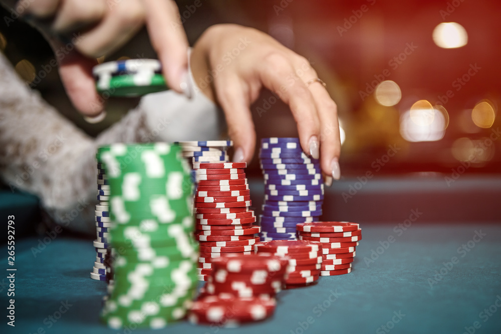 Female hands with piles of poker chips closeup Female hands with piles of poker chips closeup