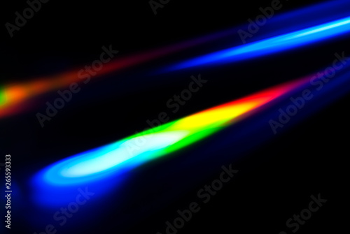 Abstract colorful spectrum in darkness. Colorful rays of light.