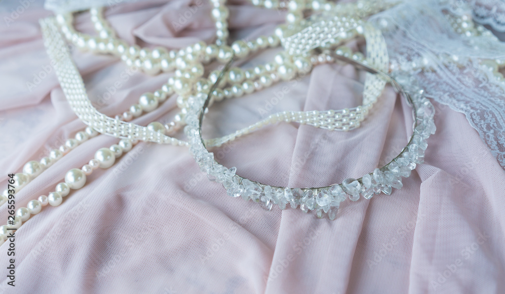 Wedding background with pearls and hair accessories on pink background Wedding background with pearls and hair accessories on pink background