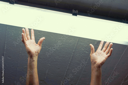 Close-up electric hands changing ceiling fluorescent lamp. The concept of repair and service. Toning