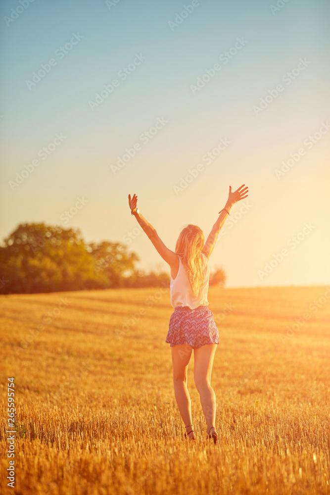 Young woman jumping and running in a wheat field. Young woman jumping and running in a wheat field.
