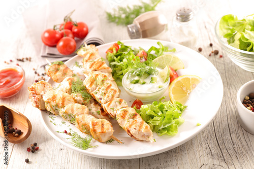 grilled chicken with salad and sauce