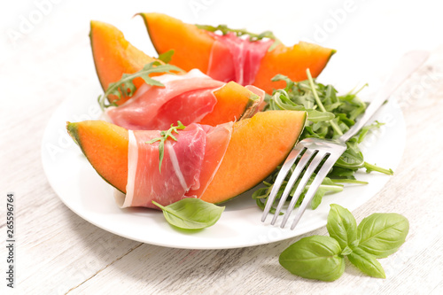 melon slice with ham and basil