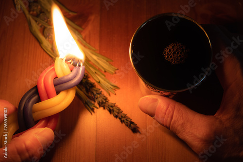 A Havdalah candle, wine cup and fragrant plant for the Havdala blessing after Shabbat