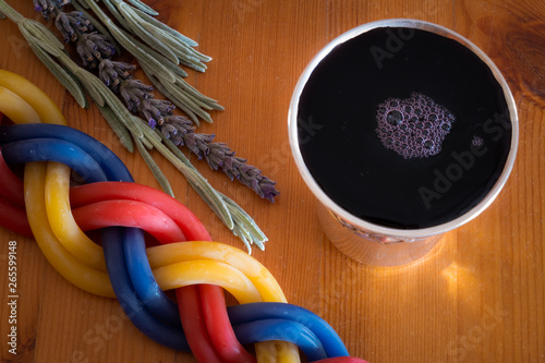 A Havdalah candle, wine cup and fragrant plant for the Havdala blessing after Shabbat