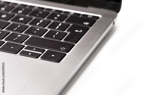 Close up of the laptop keyboard. Black keys on a light background. Silver scratched texture background.