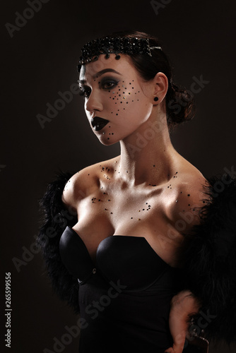 Elegant and gorgeous stylish model. Studio fashion and beauty portrait. Art concept. Black swan or dark angel idea.