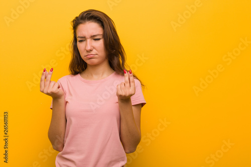 Young european woman isolated over yellow background showing that she has no money. © Asier