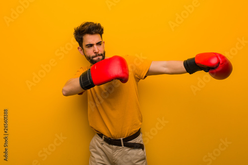 Young man wearing boxing gloves © Asier