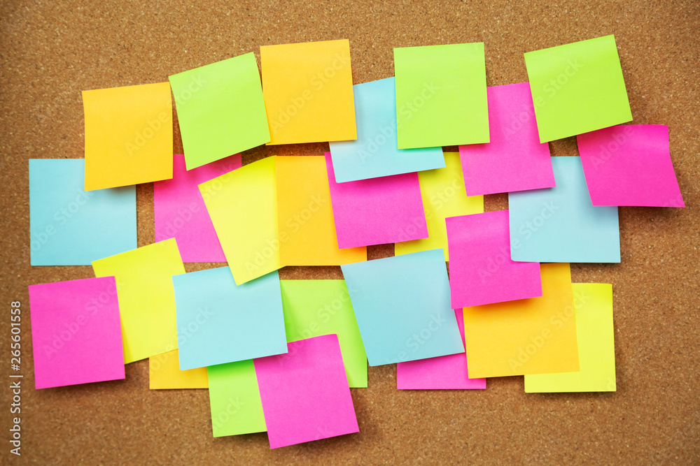 collection of colorful variety post it. paper note reminder sticky notes  pad on cork bulletin board. empty space for text. soft focus. Stock Photo