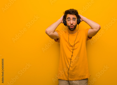 Fotografija Young man listening to music worried and overwhelmed