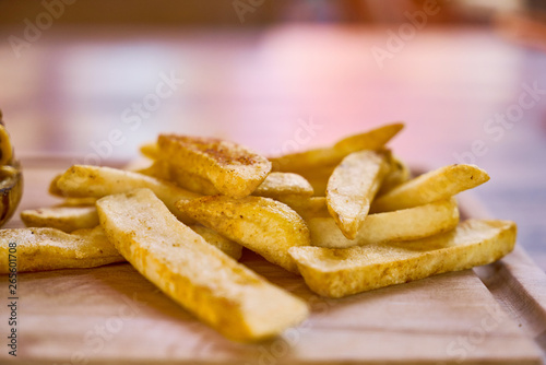 French fries on the wooden plate