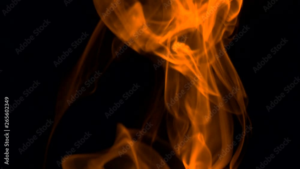Bright orange smoke slowly rising graceful twists upward. Colored smoke blowing from bottom to top. Close-up, isolated on black background Bright orange smoke slowly rising graceful twists upward. Colored smoke blowing from bottom to top. Close-up, isolated on black background