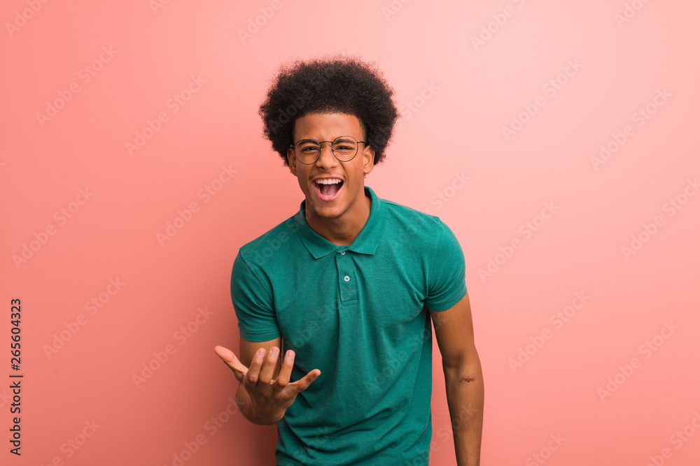 Young african american man over a pink wall very scared and afraid Young african american man over a pink wall very scared and afraid