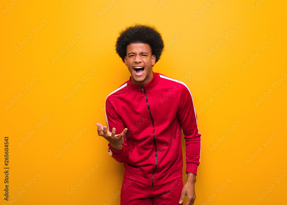 Young sport black man over an orange wall very scared and afraid Young sport black man over an orange wall very scared and afraid