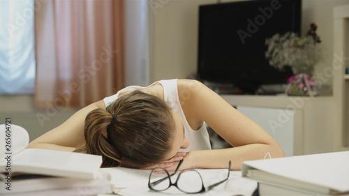 Female student sleeping instead learning