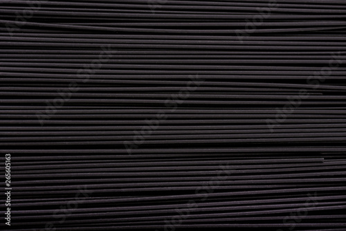 Black pasta background. Black spaghetti with squid ink, background. Pasta with black cuttlefish ink.